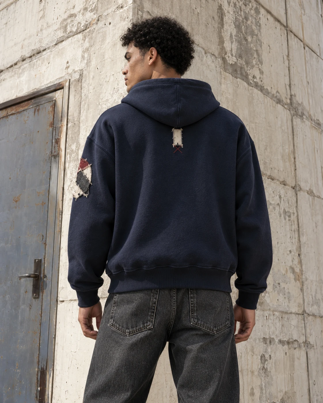 Distinct back design on the same model — Appliqué & Embroidered Hoodie in navy / bone / oxblood, AI-generated design concept
