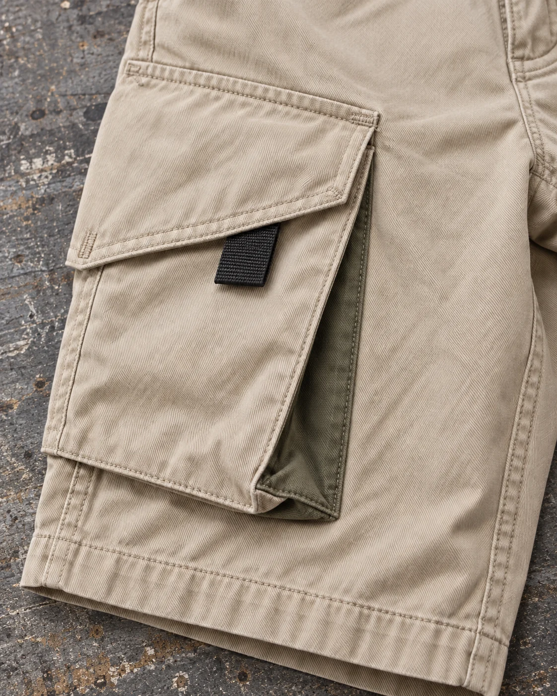 Close-up of fabric and signature construction — Baggy Cargo Shorts in sand / olive, AI-generated design concept