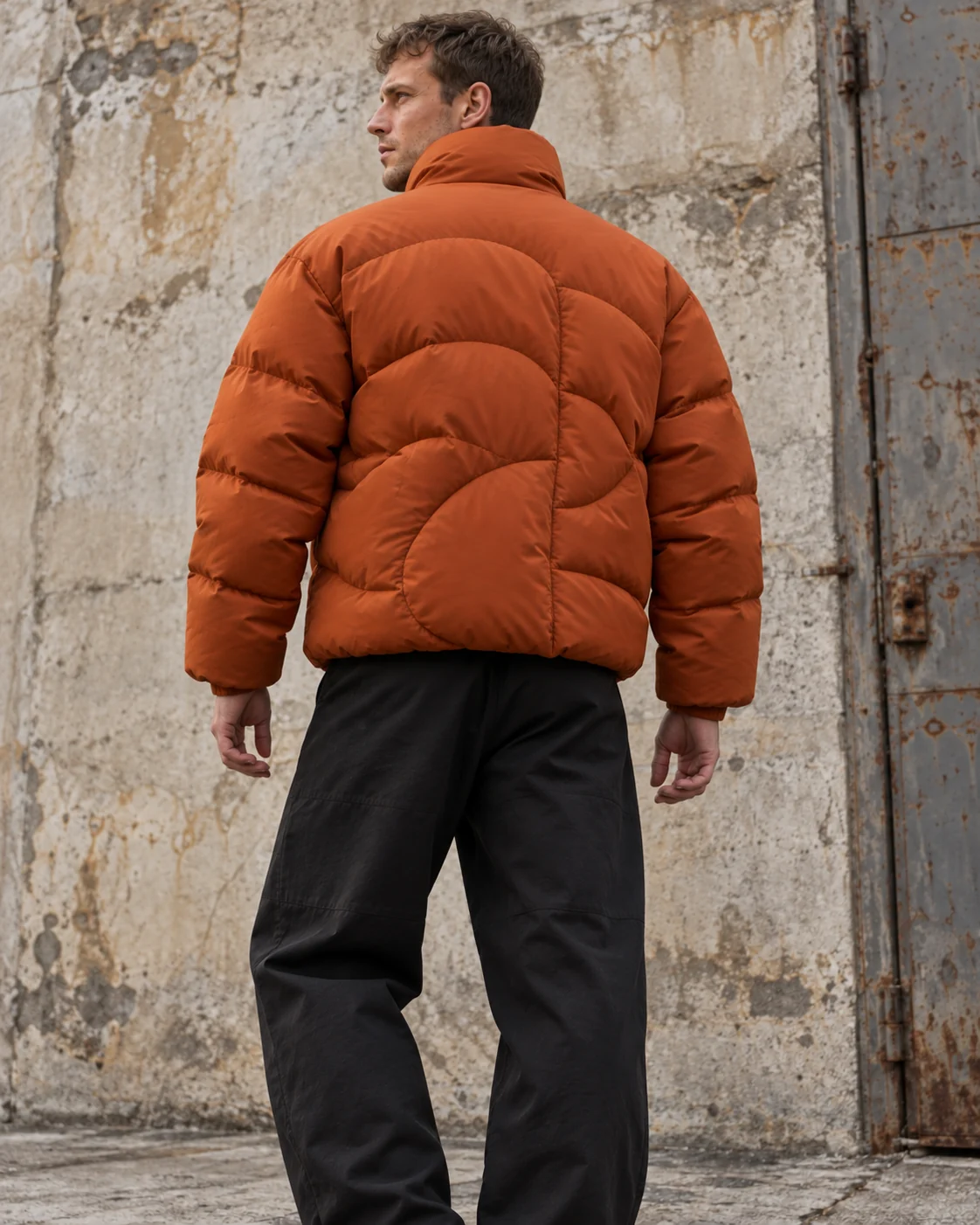 Distinct back design on the same model — Boxy Puffer Jacket in burnt orange / charcoal, AI-generated design concept