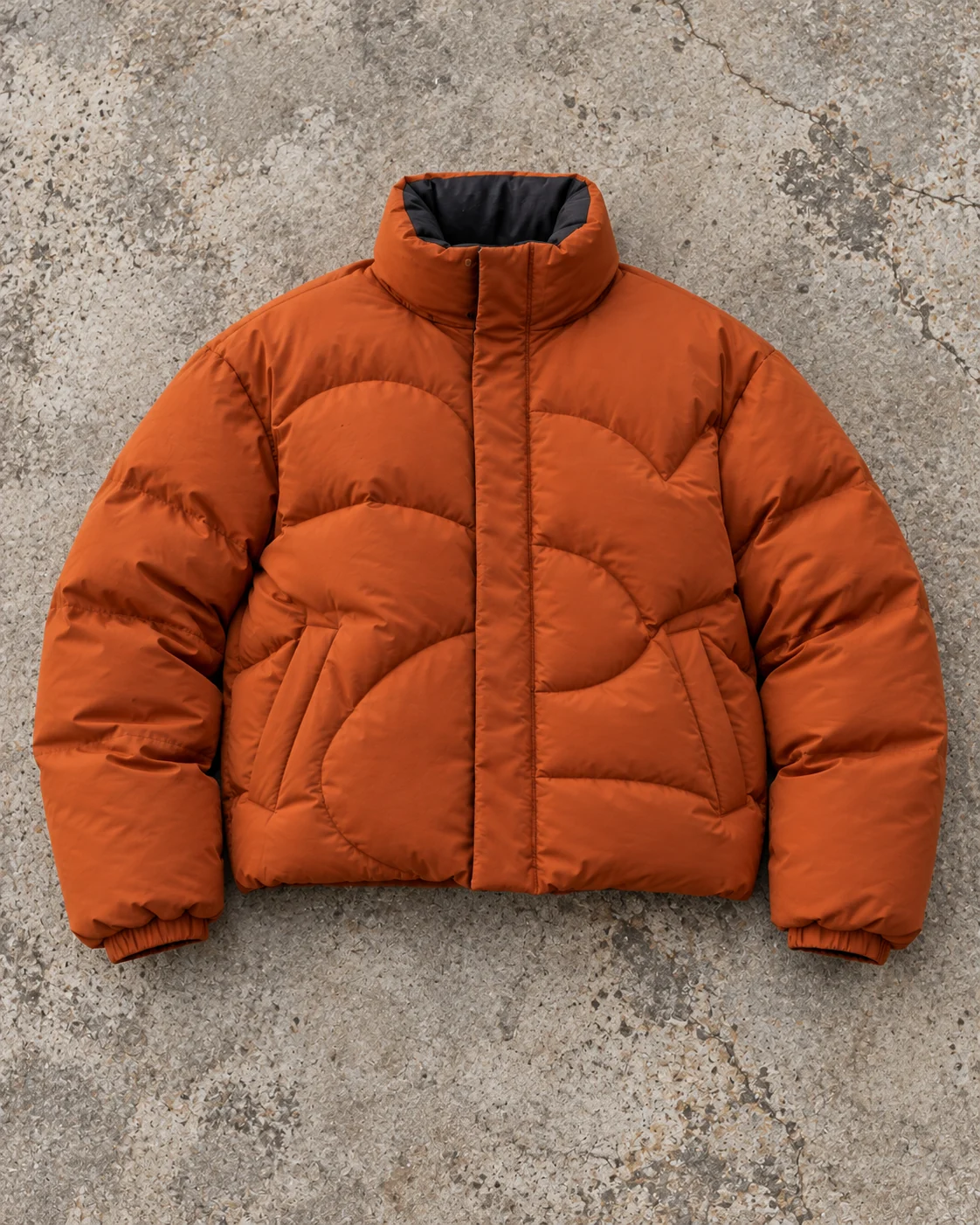 Full garment flat-lay showing the cut — Boxy Puffer Jacket in burnt orange / charcoal, AI-generated design concept