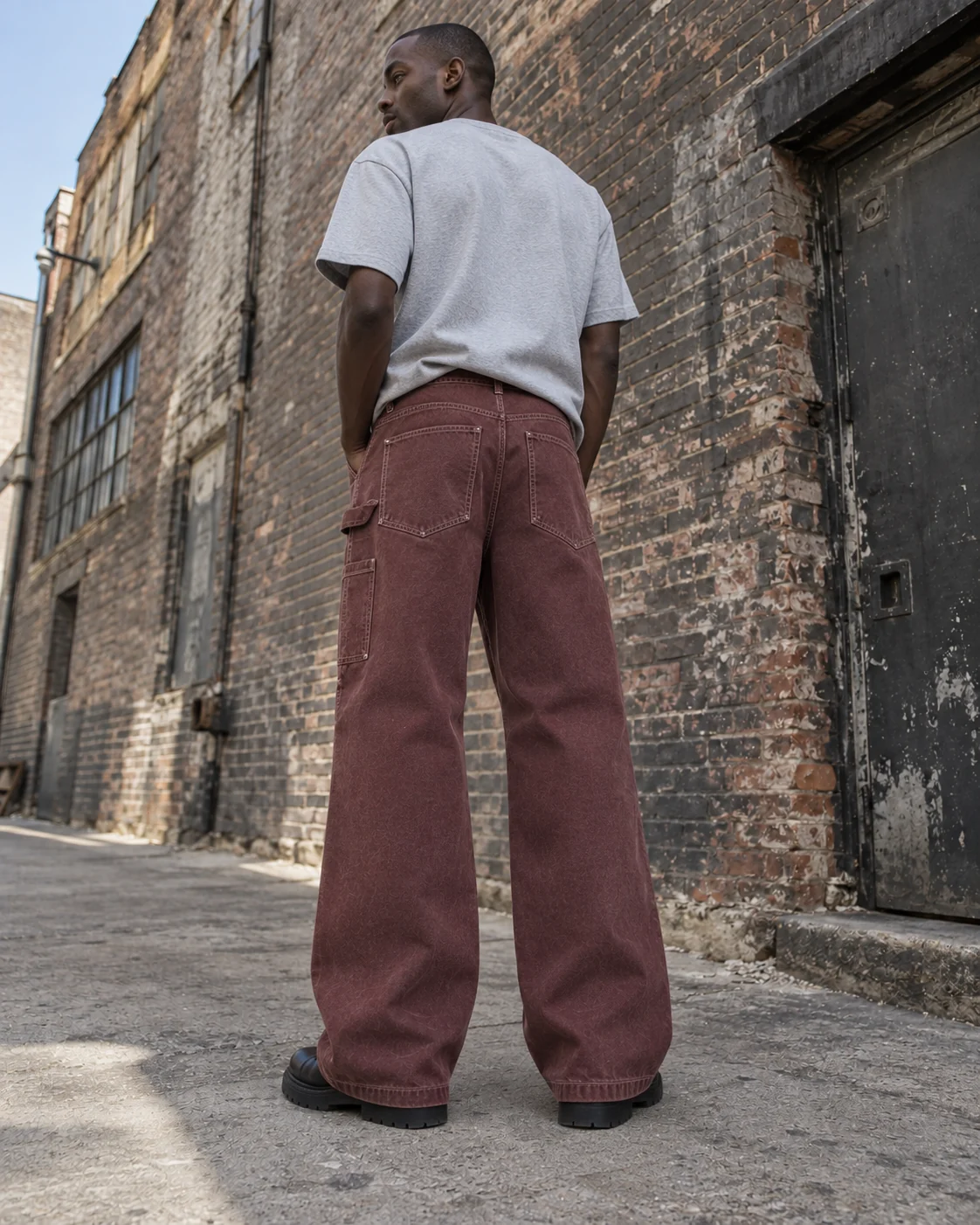 Distinct back design on the same model — Canvas Carpenter Pants in faded oxblood / chalk, AI-generated design concept