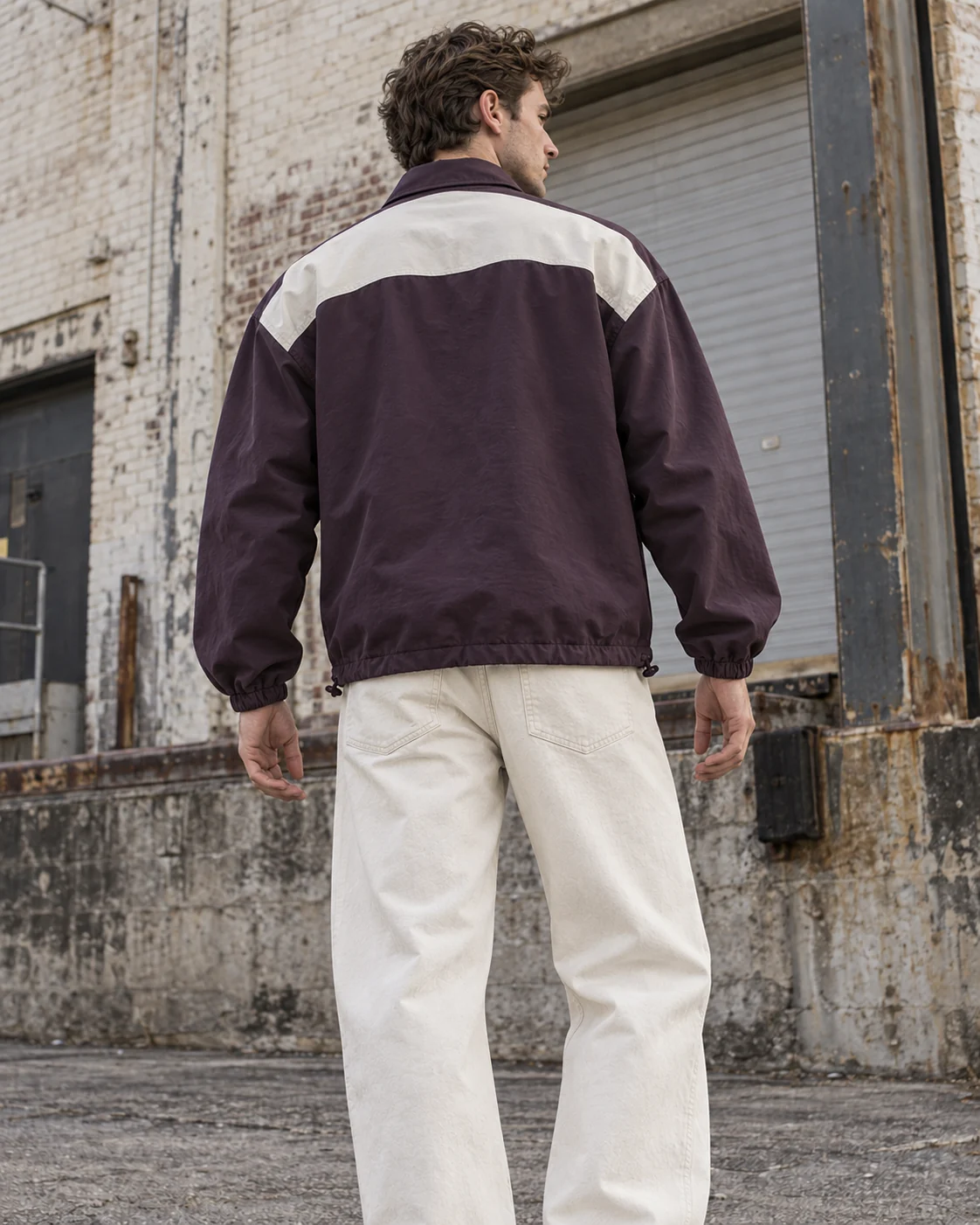 Distinct back design on the same model — Coach Jacket in washed aubergine / bone, AI-generated design concept