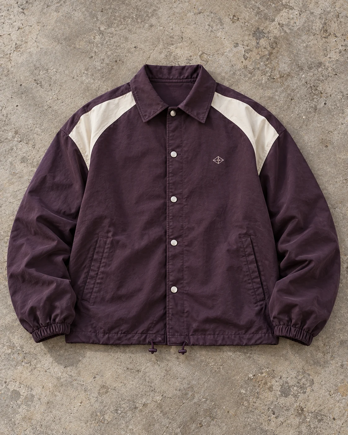 Full garment flat-lay showing the cut — Coach Jacket in washed aubergine / bone, AI-generated design concept