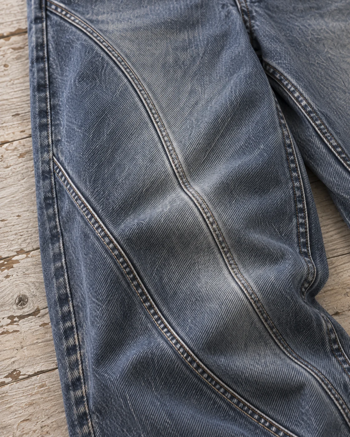 Close-up of fabric and signature construction — Curved-Panel Jeans in slate blue / smoke grey, AI-generated design concept