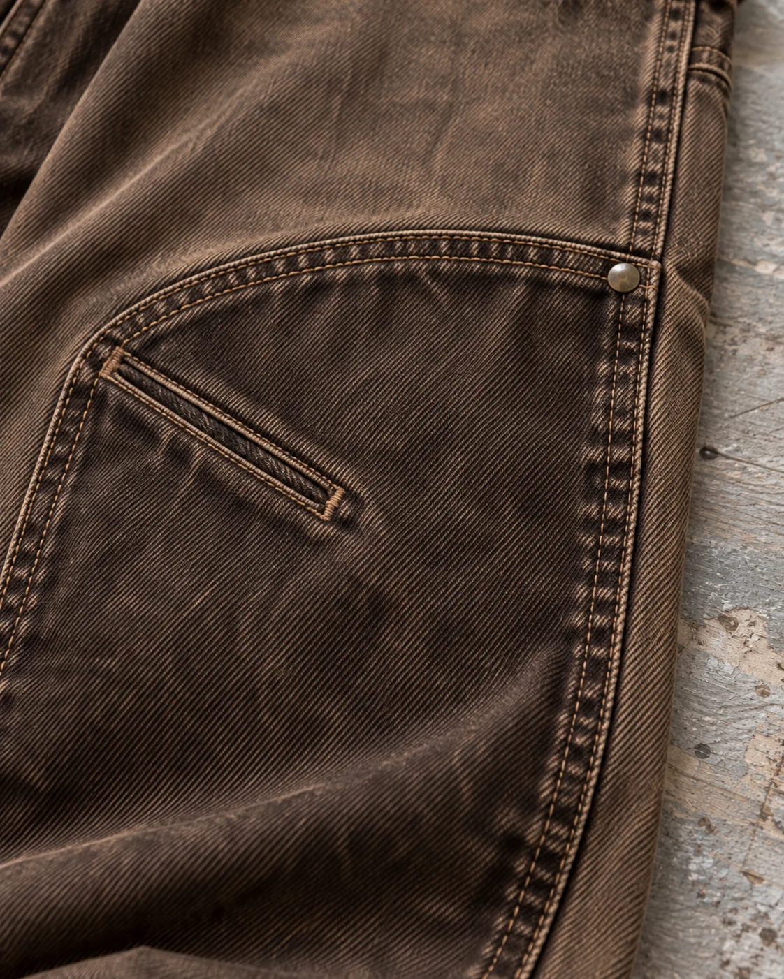Close-up of fabric and signature construction — Double-Knee Carpenter Jeans in tobacco brown / dark umber, AI-generated design concept