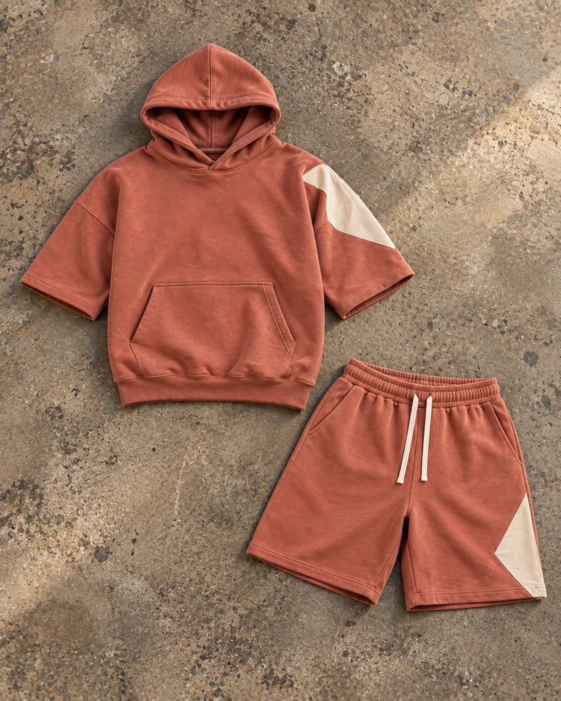 Complete top and bottom flat-lay showing their proportions — Hoodie & Shorts Set in faded clay / bone, AI-generated design concept