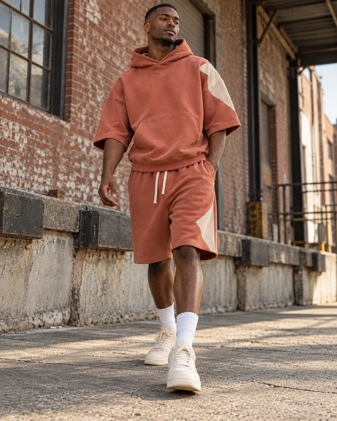 Full-body streetwear styling of the matching set — Hoodie & Shorts Set in faded clay / bone, AI-generated design concept