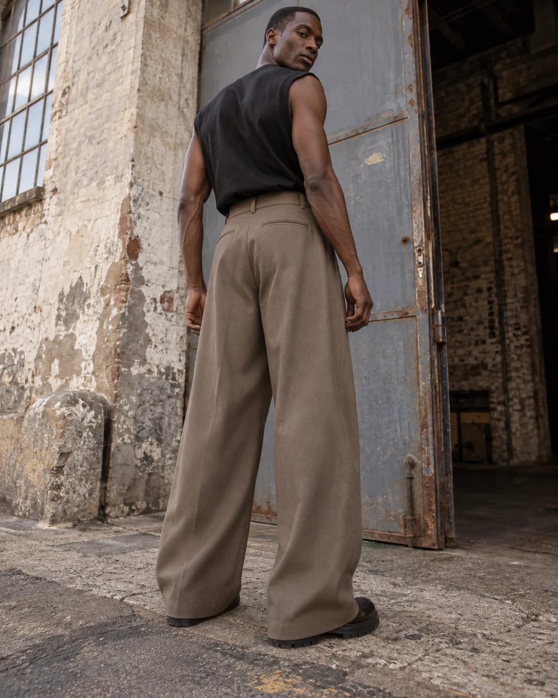 Distinct back design on the same model — Pleated Wide-Leg Trousers in warm taupe / tonal, AI-generated design concept