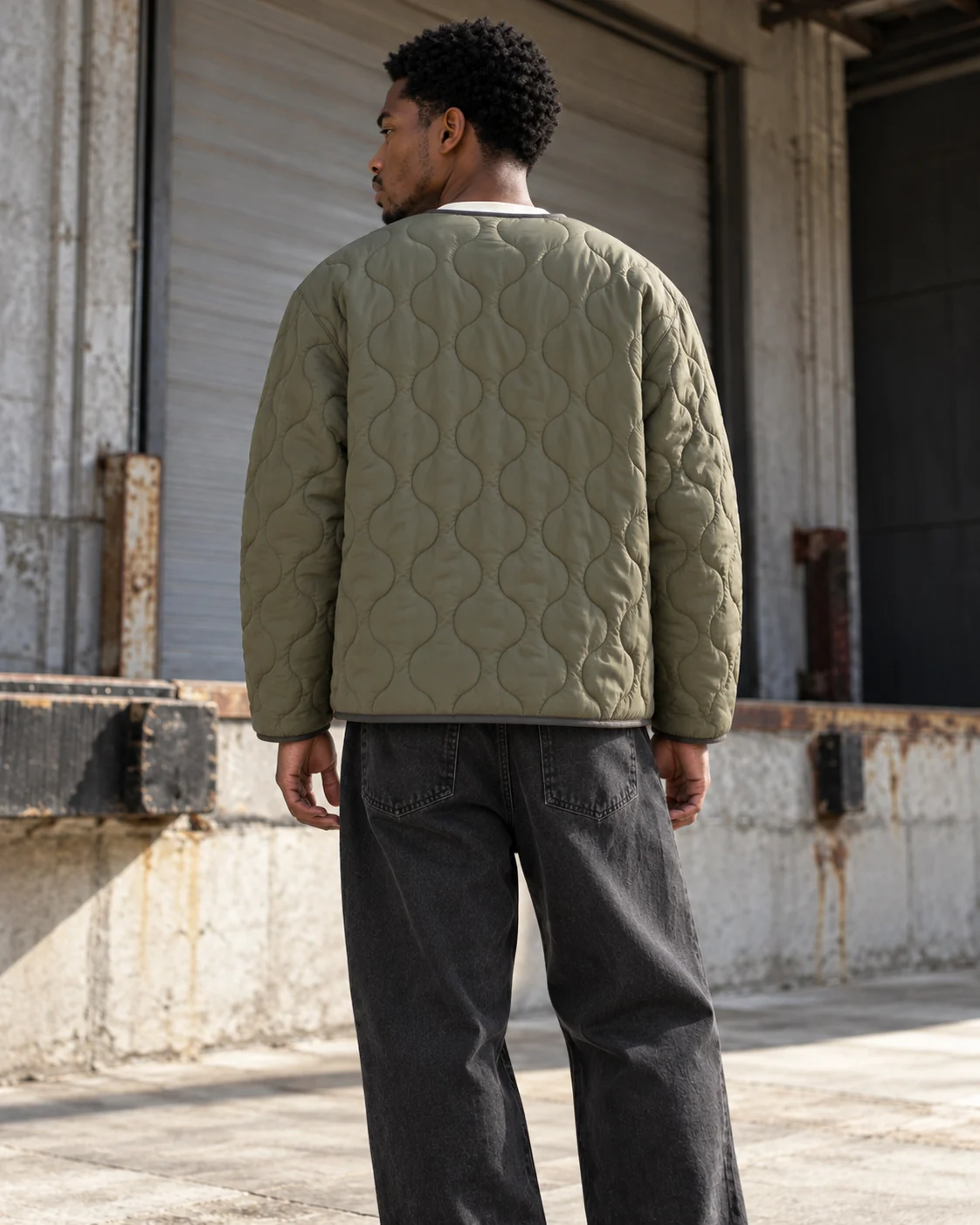 Distinct back design on the same model — Quilted Liner Jacket in dusty moss / charcoal, AI-generated design concept