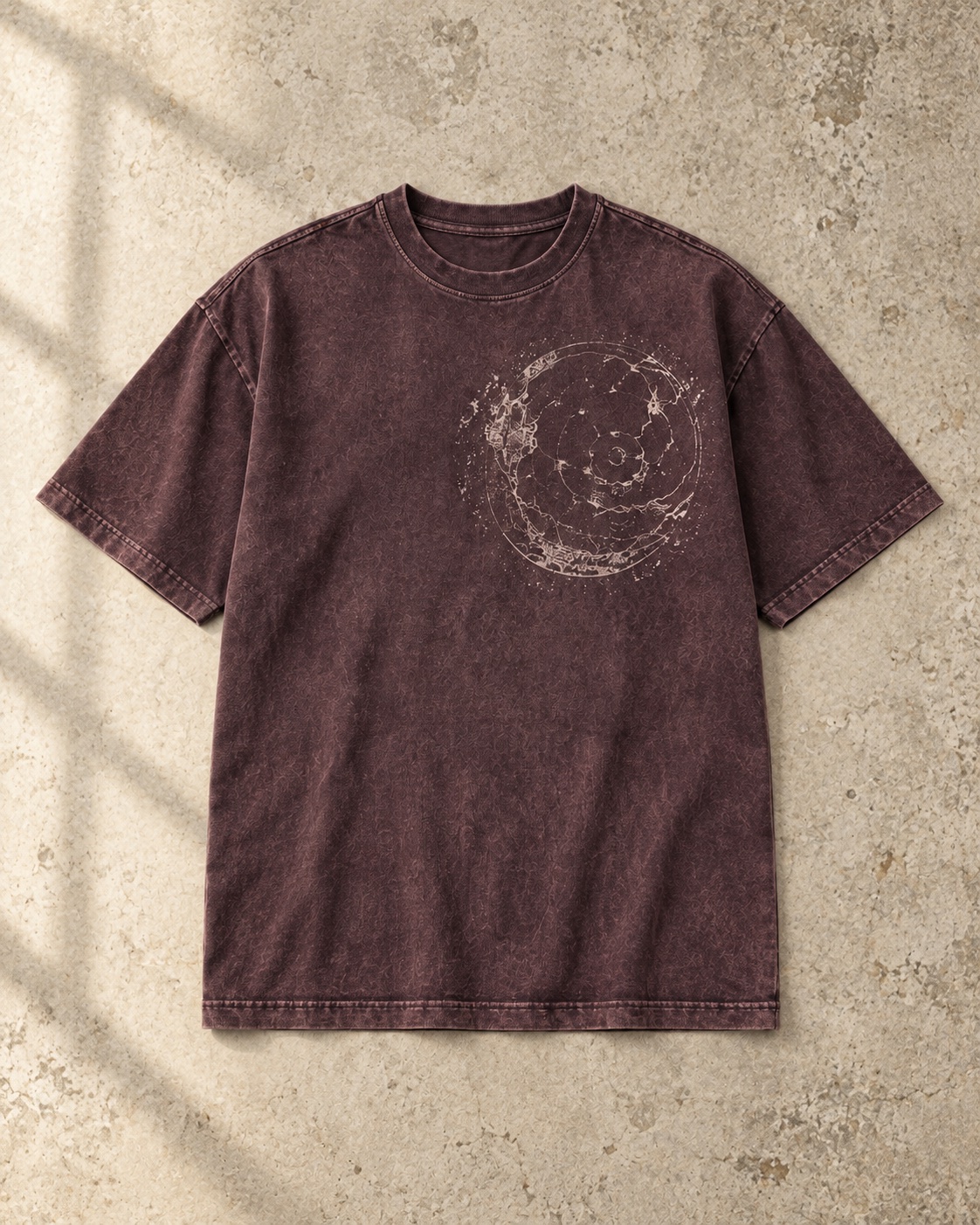 Flat-lay of the original faded plum vintage-finish T-shirt showing a relaxed straight body, generous sleeves, rib collar and small circular chest print