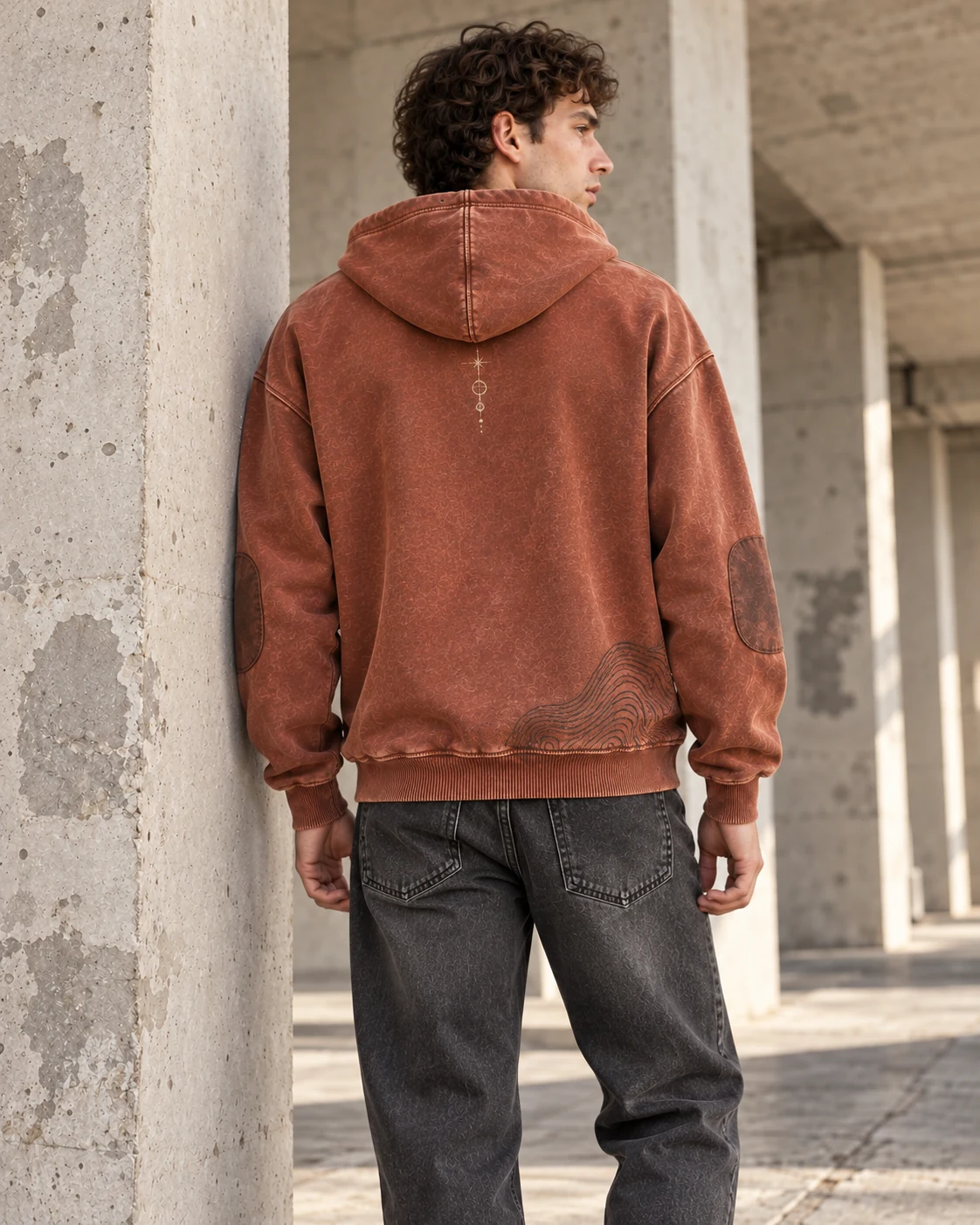 Distinct back design on the same model — Vintage Wash Hoodie in faded rust / charcoal / cream, AI-generated design concept