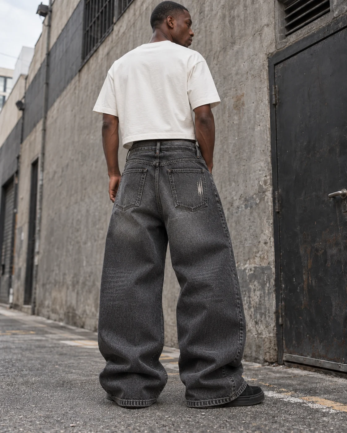 Distinct back design on the same model — Vintage-Wash Graphic Jeans in washed charcoal / bone, AI-generated design concept