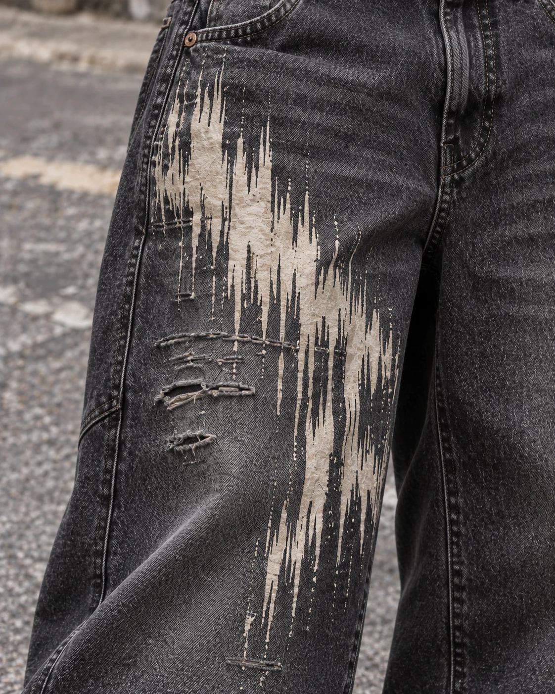 Close-up of fabric and signature construction — Vintage-Wash Graphic Jeans in washed charcoal / bone, AI-generated design concept
