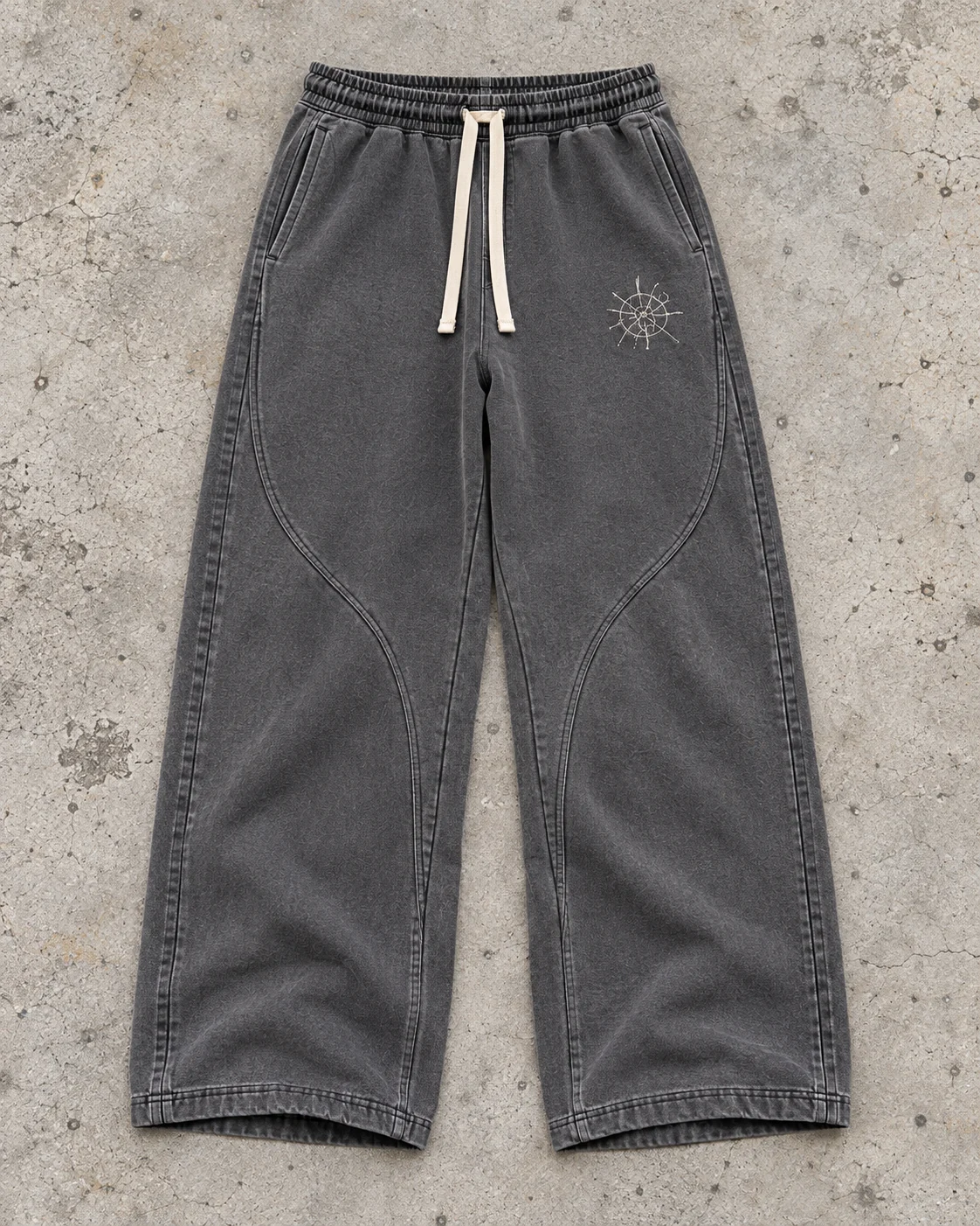 Full garment flat-lay showing the cut — Wide-Leg Sweatpants in washed graphite / bone, AI-generated design concept